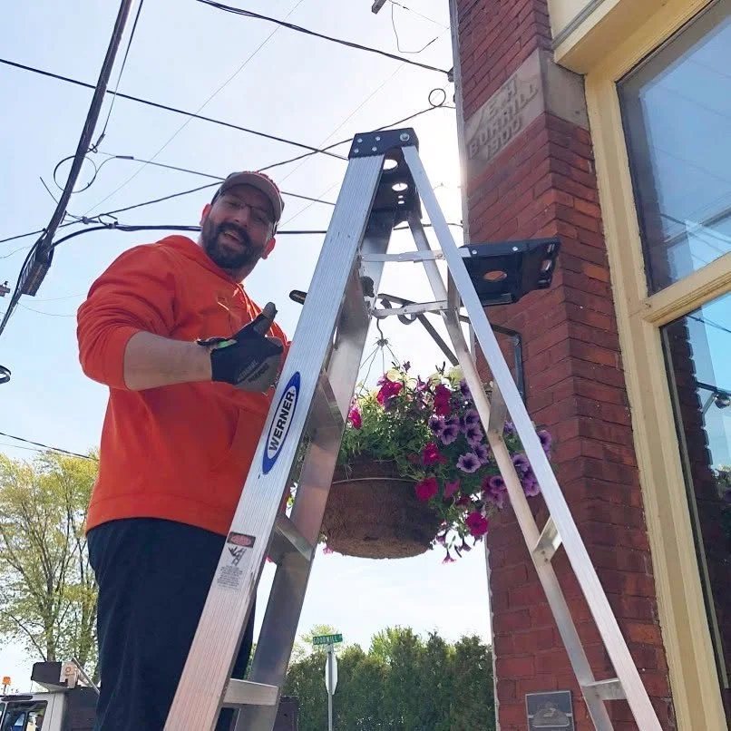 Hanging flowers outside a brick storefront
