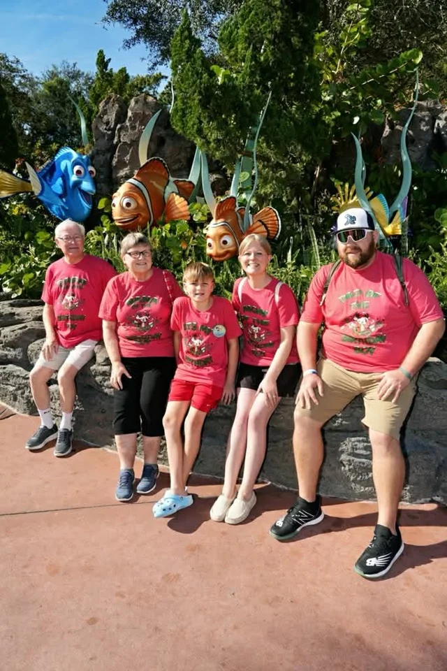 Family wearing matching red printed shirts