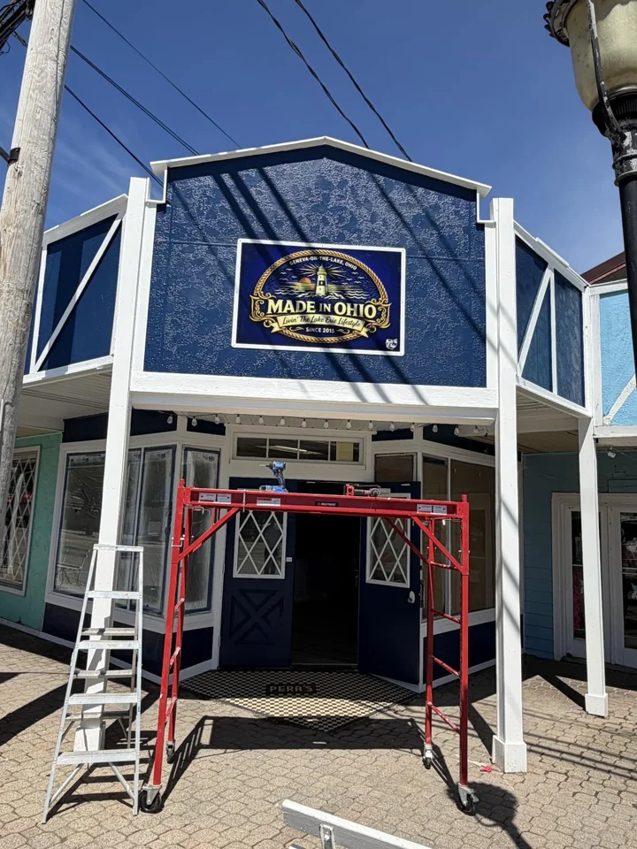 Navy and white Geneva-on-the-Lake storefront during exterior work